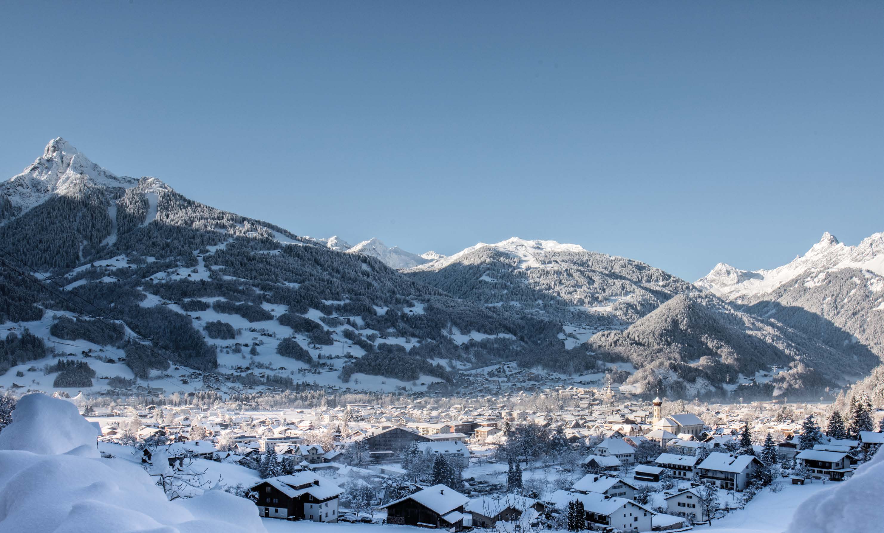Schruns in winter with snow-covered roofs and the Zimba in the background